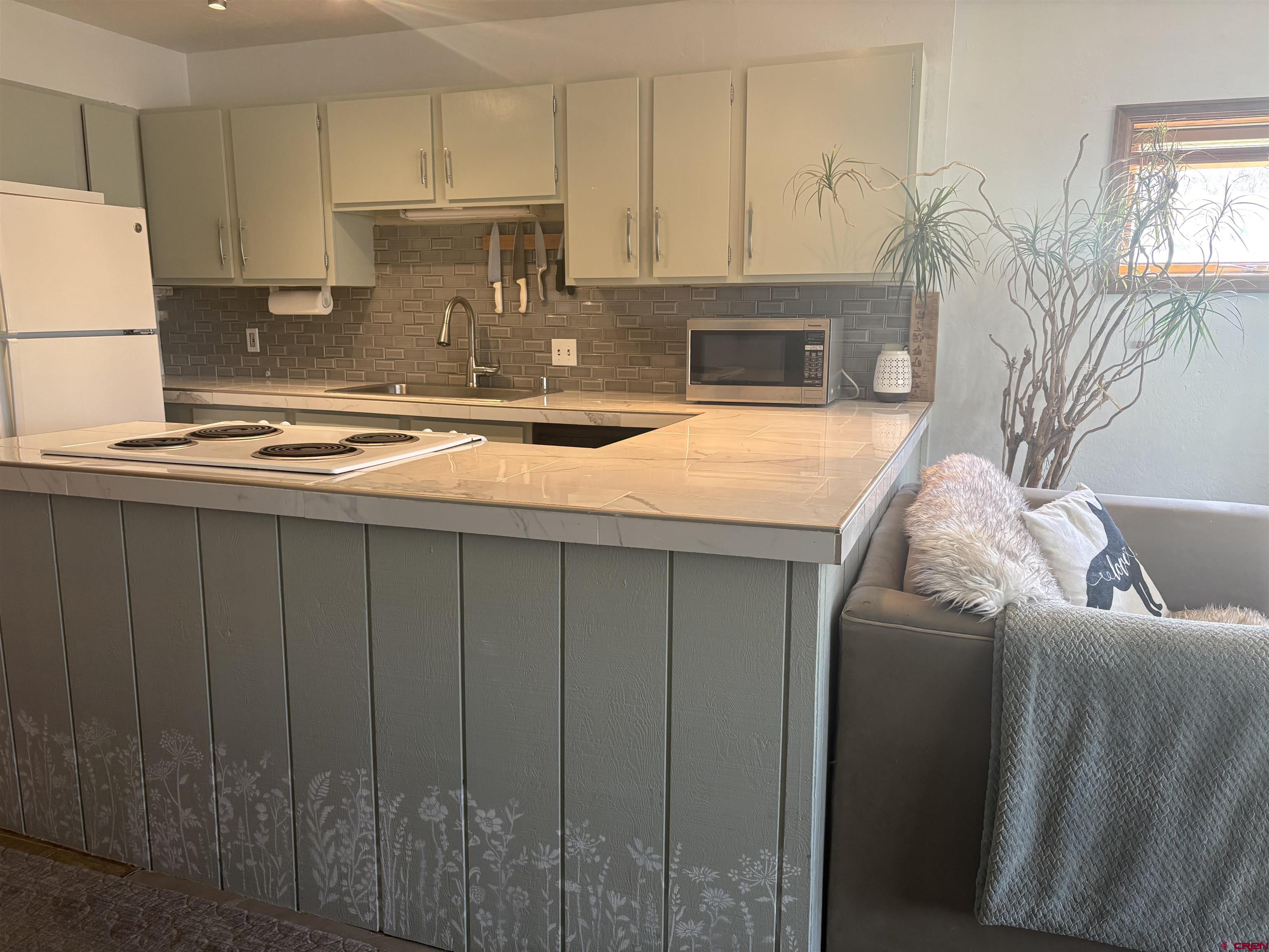 26 Castle Road, Unit 3 Crested Butte, CO 81225 - Photo 3 of 32 a kitchen with a sink refrigerator and cabinets