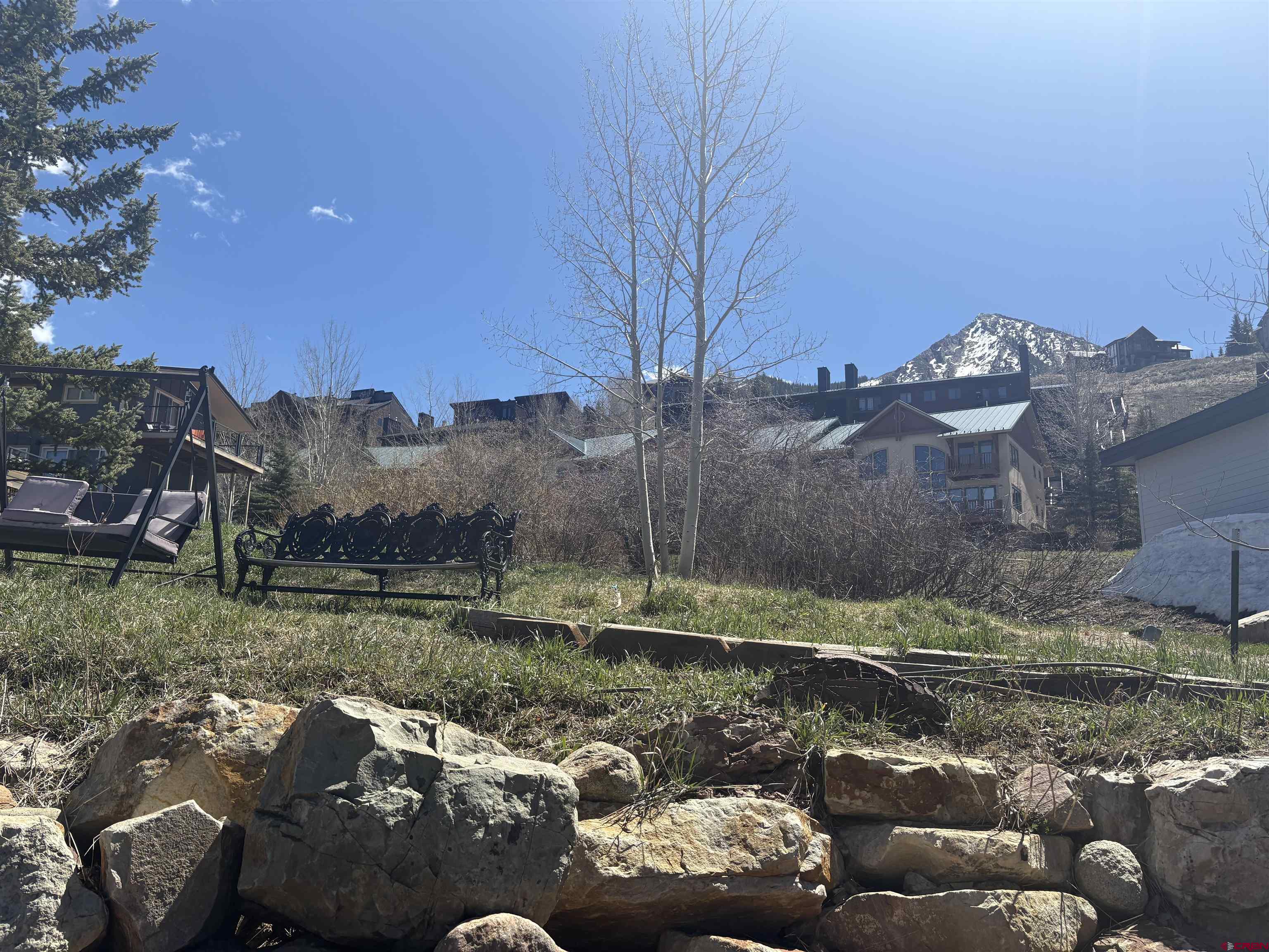 26 Castle Road, Unit 3 Crested Butte, CO 81225 - Photo 31 of 32 a backyard of a house with table and chairs