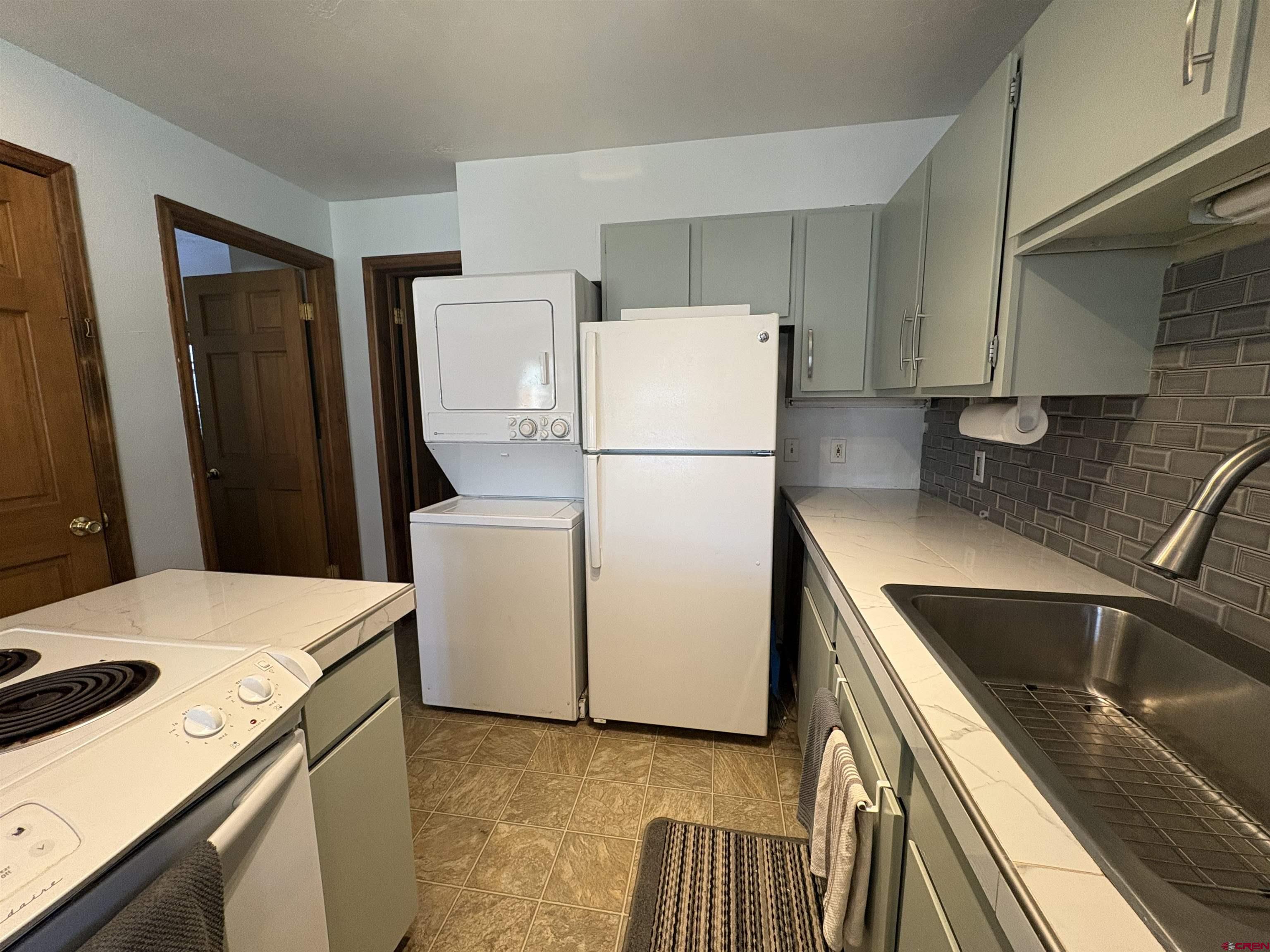 26 Castle Road, Unit 3 Crested Butte, CO 81225 - Photo 4 of 32 a kitchen with a refrigerator sink and stove