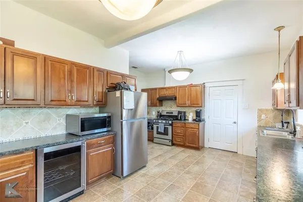 a kitchen with stainless steel appliances granite countertop a stove a sink dishwasher and a stove with granite countertops