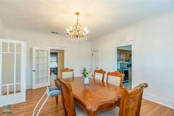 a view of a dining room with furniture and chandelier