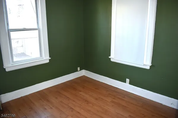 a view of a room with wooden floor and windows