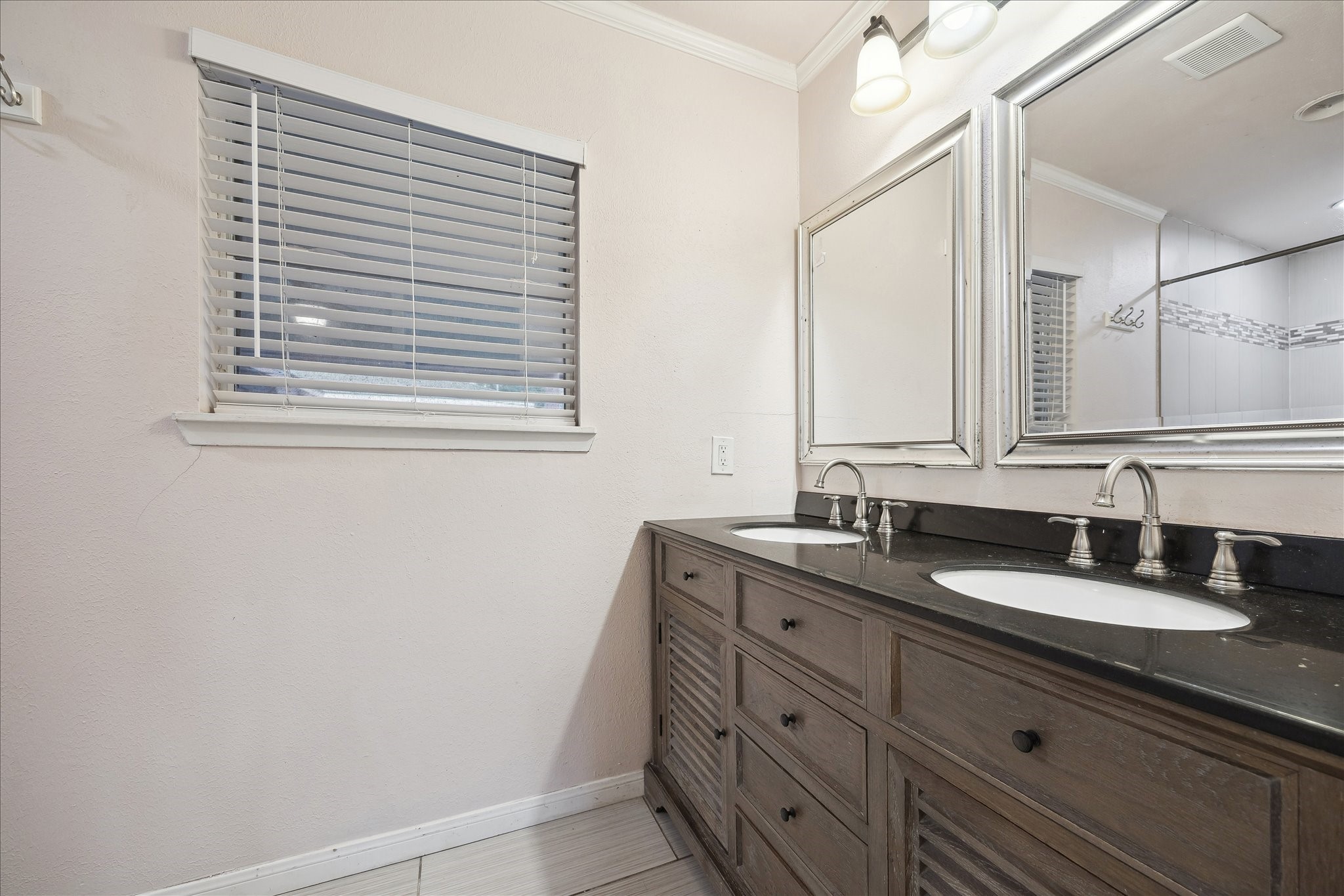 11519 Endicott Lane Houston, TX 77035 - Photo 13 of 25 a bathroom with a granite countertop sink and a mirror