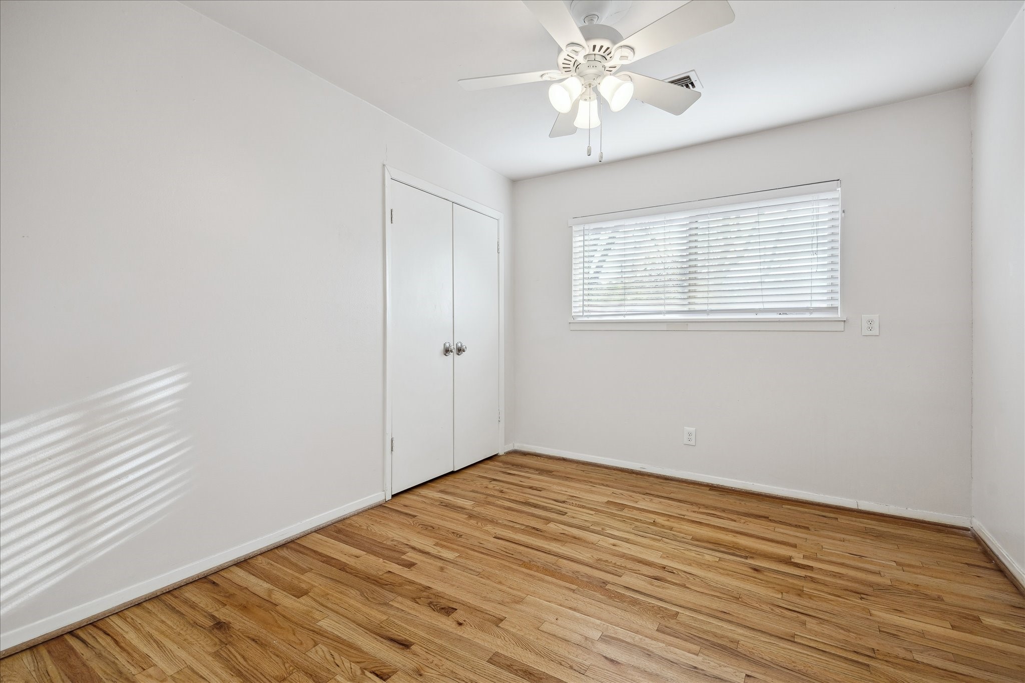 11519 Endicott Lane Houston, TX 77035 - Photo 15 of 25 wooden floor in an empty room with a window