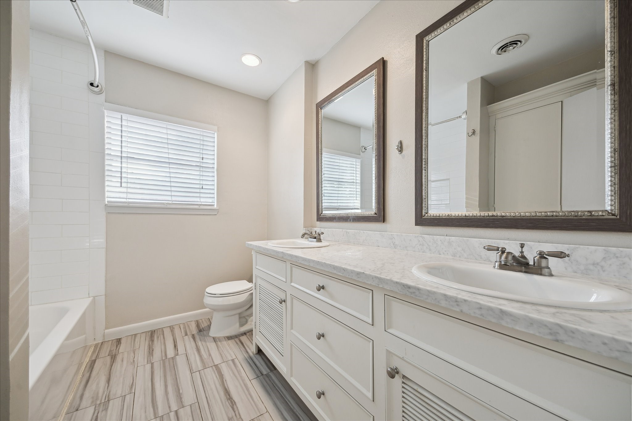 11519 Endicott Lane Houston, TX 77035 - Photo 16 of 25 a bathroom with a granite countertop toilet a sink and a mirror