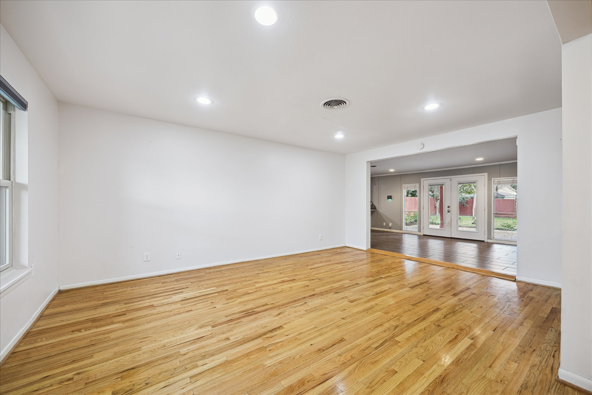 11519 Endicott Lane Houston, TX 77035 - Photo 3 of 25 a view of an empty room with window and wooden floor