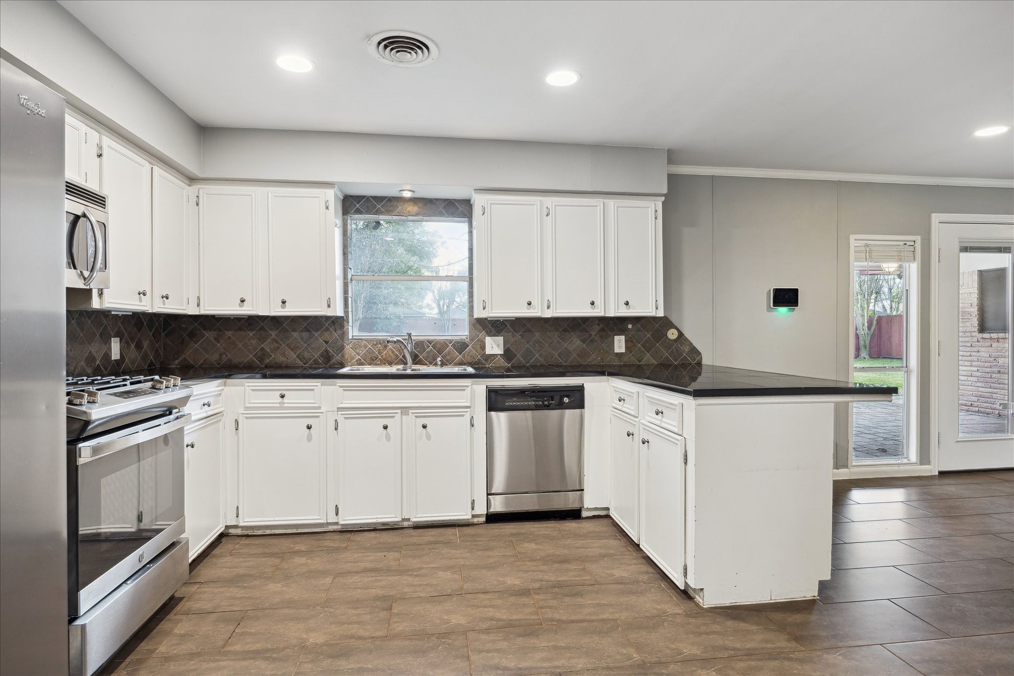 11519 Endicott Lane Houston, TX 77035 - Photo 7 of 25 a kitchen with stainless steel appliances granite countertop a stove a sink and white cabinets