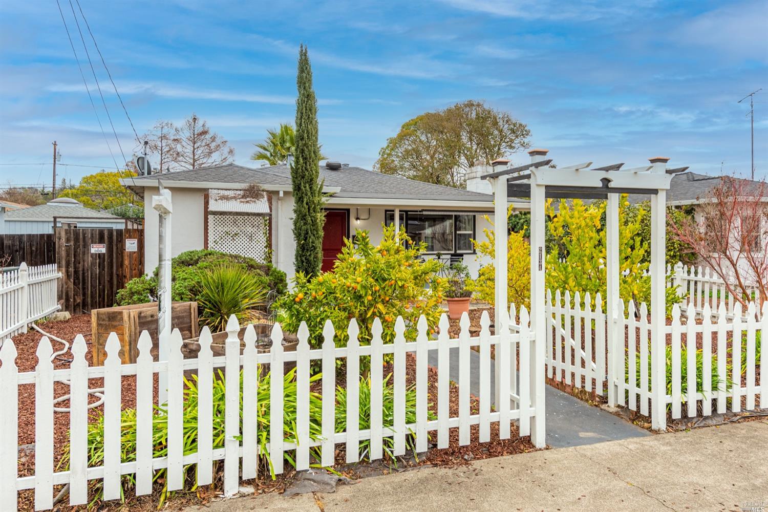a front view of a house with a garden