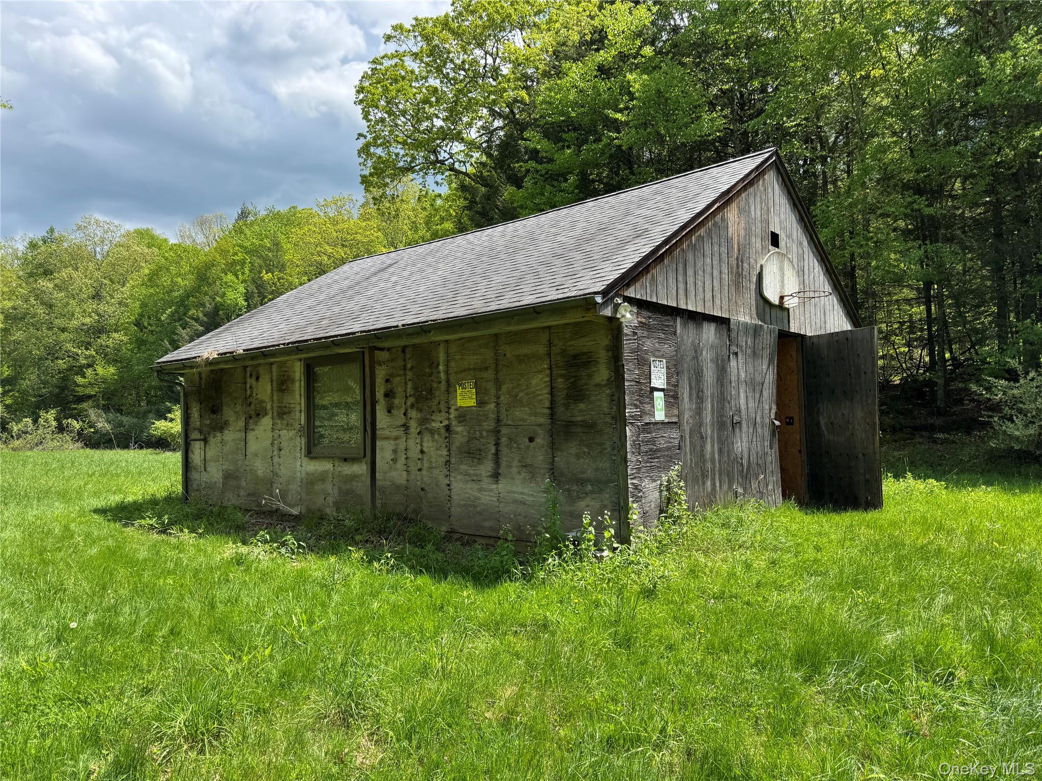 632 New Turnpike Road Cochecton, NY 12726 - Photo 10 of 28 a view of a barn house with a big yard plants and large trees