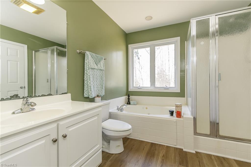 6052 David Moore Road Elon, NC 27244 - Photo 13 of 30 Tile surround jetted tub, walk-in shower and walk in closet of 9.8' x 3.8'