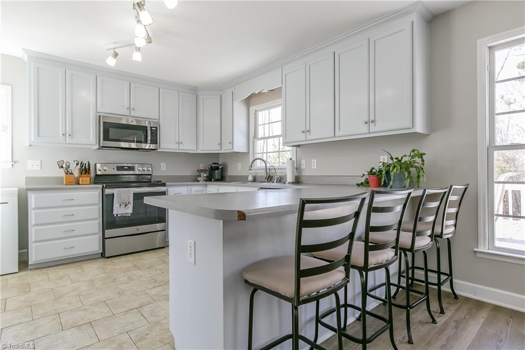6052 David Moore Road Elon, NC 27244 - Photo 8 of 30 Tile flooring, crisp white cabinets and soft greys