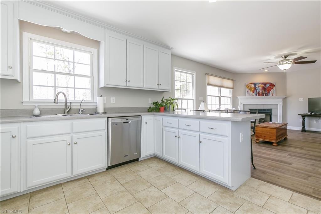 6052 David Moore Road Elon, NC 27244 - Photo 10 of 30 Stainless sink, high bar seating and wonderful views
