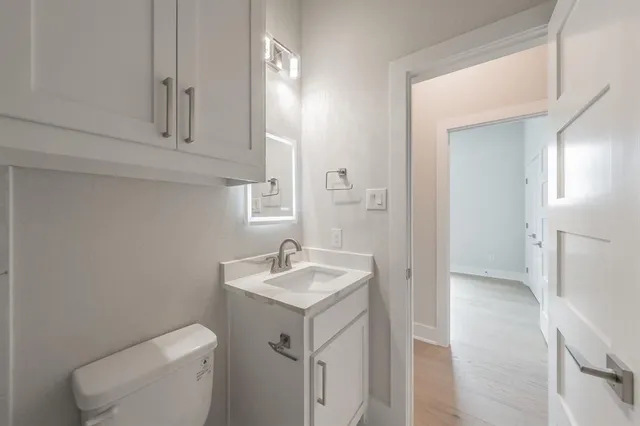 a view of an empty room with a kitchen