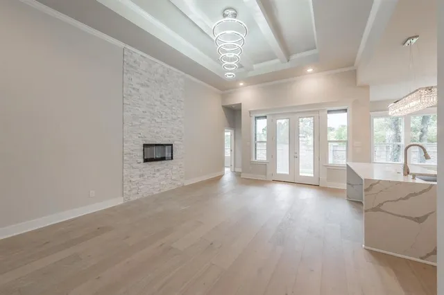 a large white kitchen with a stove top oven