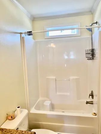a bathroom with a bathtub and a shower
