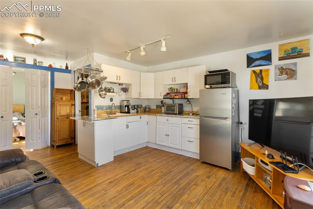 209 5th Street Victor, CO 80860 - Photo 11 of 36 a kitchen with stainless steel appliances a refrigerator sink and microwave