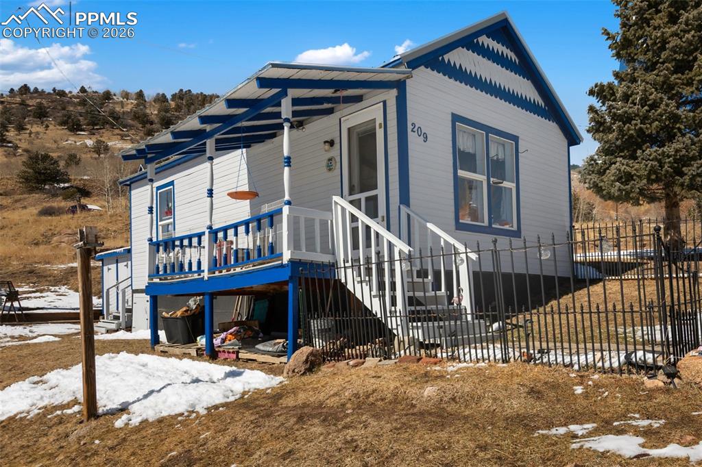 209 5th Street Victor, CO 80860 - Photo 2 of 36 a view of a house with a wooden deck