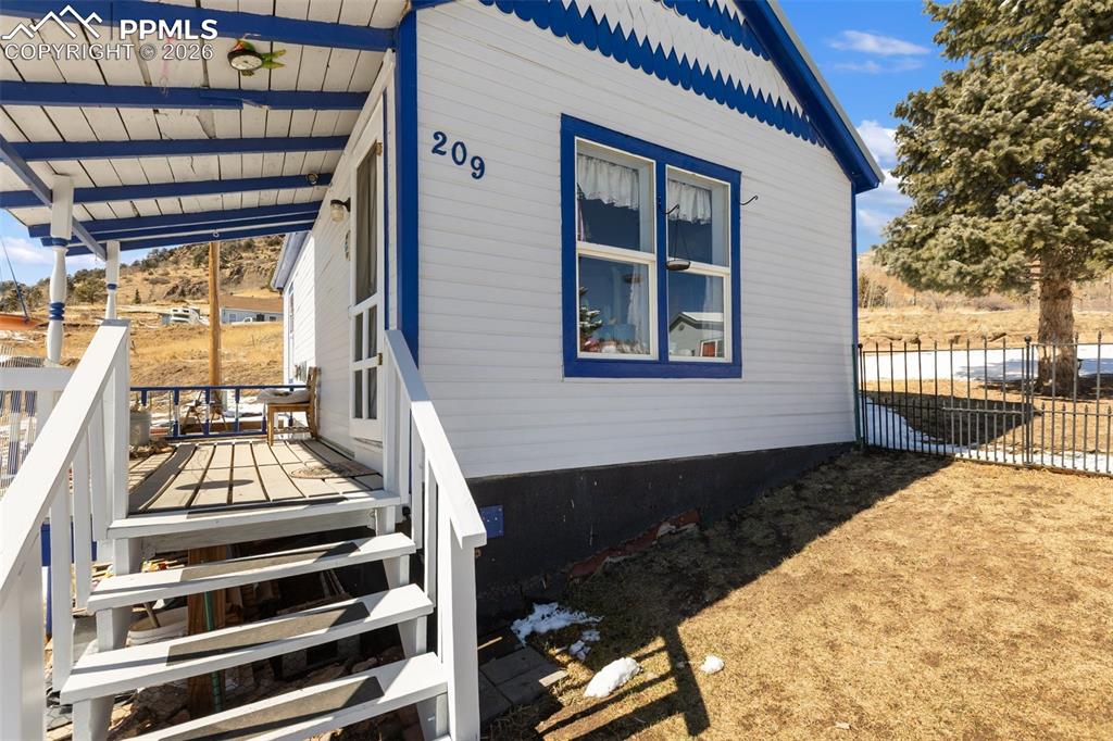 209 5th Street Victor, CO 80860 - Photo 3 of 36 a view of a balcony with wooden floor and outdoor space