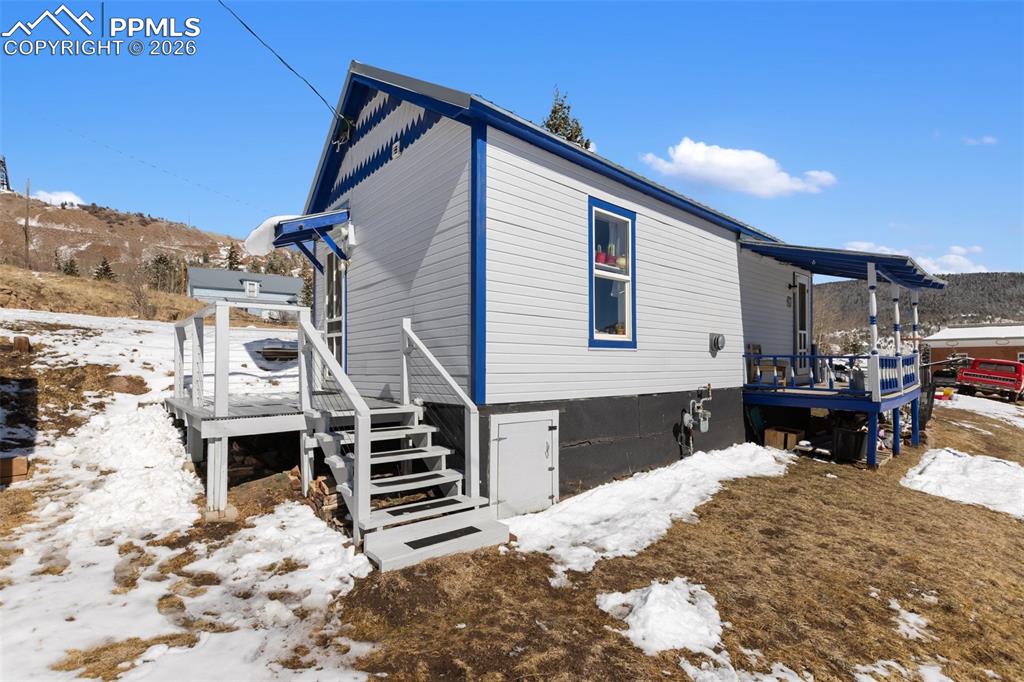 209 5th Street Victor, CO 80860 - Photo 8 of 36 a front view of a house with a yard