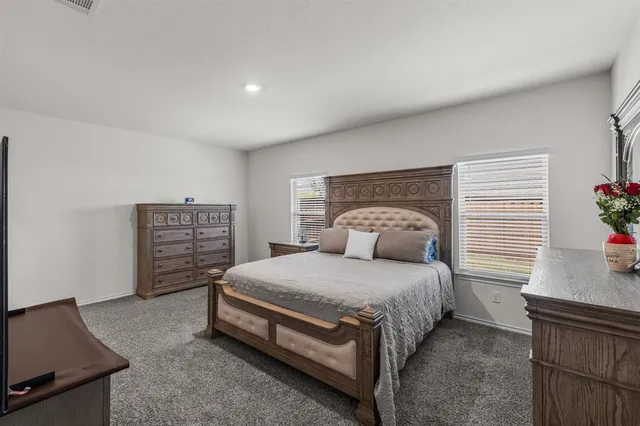 a bedroom with a bed and a potted plant