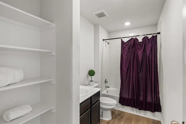 a bathroom with a toilet a sink and tub