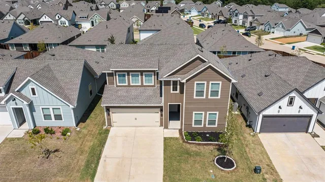 an aerial view of a house with swimming pool