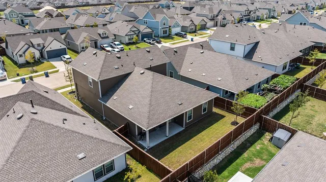 an aerial view of residential houses with outdoor space