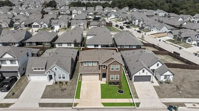 an aerial view of residential houses with outdoor space