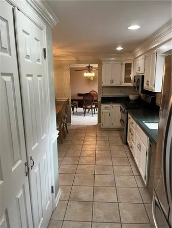a kitchen with stainless steel appliances granite countertop a refrigerator and a stove