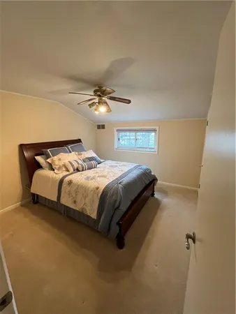 a bedroom with a bed and lamp