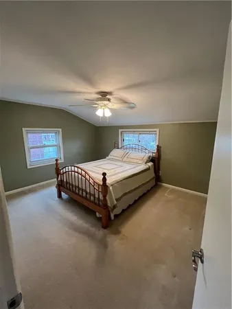a bedroom with a bed and lamp with window