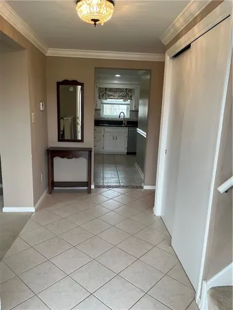 a view of a hallway with entryway and dining room view