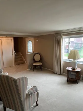 a living room with furniture and a mirror