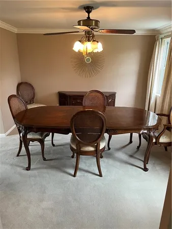 a view of a dining room with furniture and a chandelier