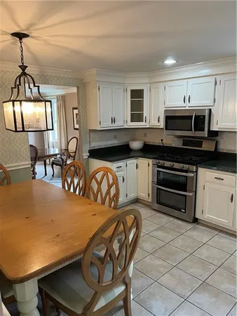 a kitchen with stainless steel appliances granite countertop a stove a sink a microwave and a refrigerator