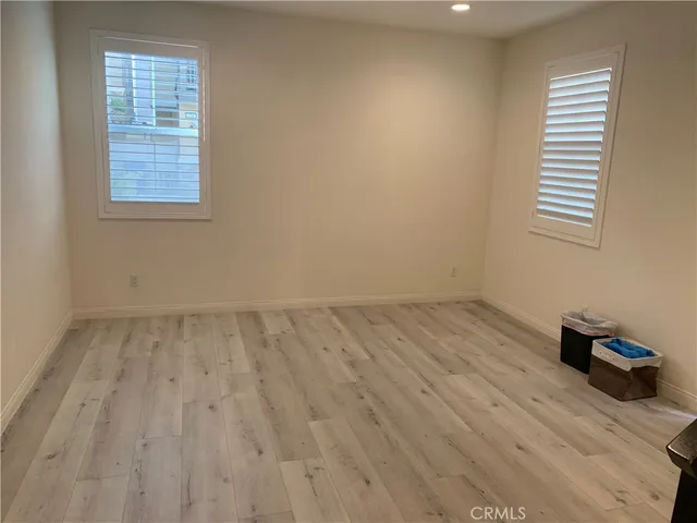 a view of a hallway with wooden floor and entryway