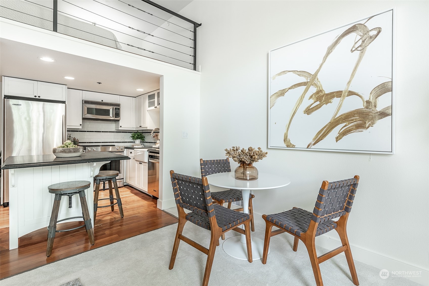 201 Galer Street, Unit 334 Seattle, WA 98109 - Photo 11 of 19 a view of a dining room with furniture and a wooden floor
