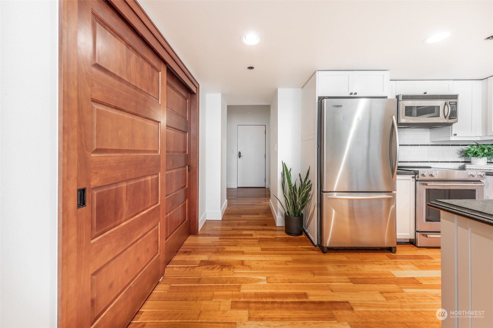 201 Galer Street, Unit 334 Seattle, WA 98109 - Photo 4 of 19 a view of a refrigerator in kitchen and an empty room