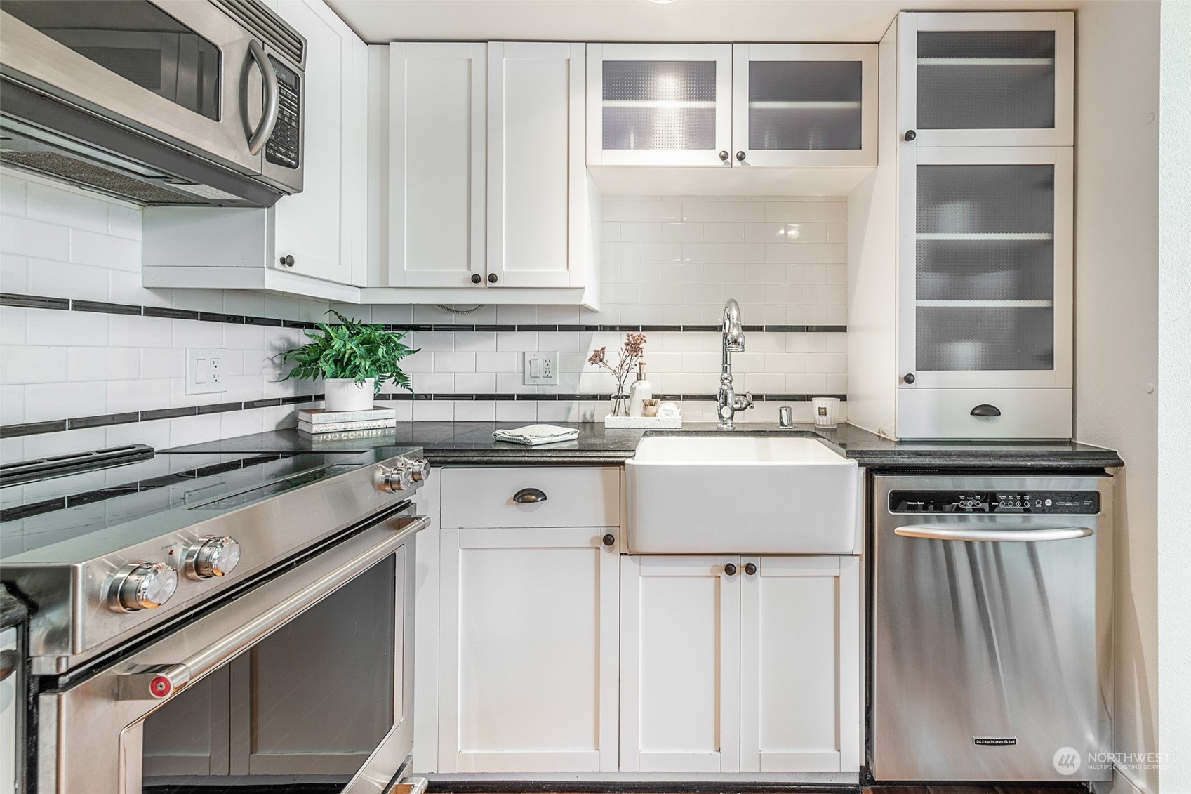 201 Galer Street, Unit 334 Seattle, WA 98109 - Photo 6 of 19 a kitchen with stainless steel appliances granite countertop a stove and a sink