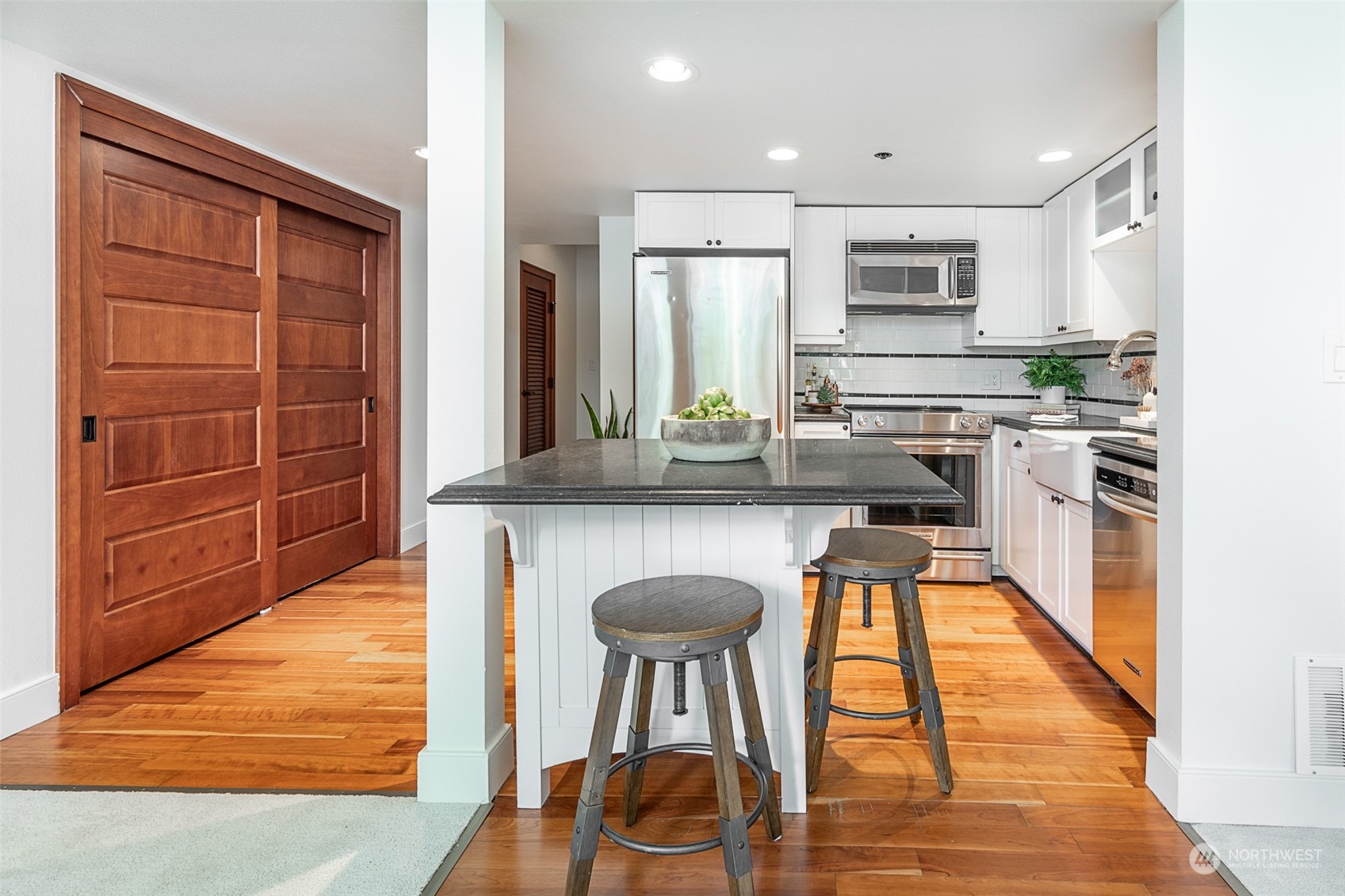 201 Galer Street, Unit 334 Seattle, WA 98109 - Photo 7 of 19 a kitchen with stainless steel appliances granite countertop a stove a sink and a refrigerator