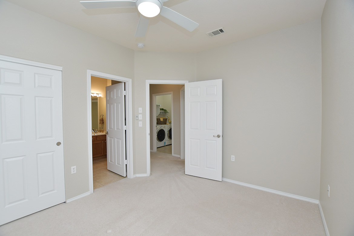 203 Winter Drive Georgetown, TX 78633 - Photo 20 of 29 Two guest bedrooms and guest bath are nicely separated from the primary bedroom at the back of the home. This one offers a door directly into the guest bath, so it can become an en-suite bath when guests visit.