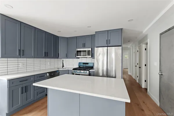 a kitchen with a sink a stove a refrigerator and cabinets