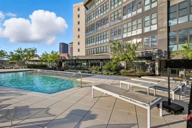 a swimming pool with outdoor seating and yard