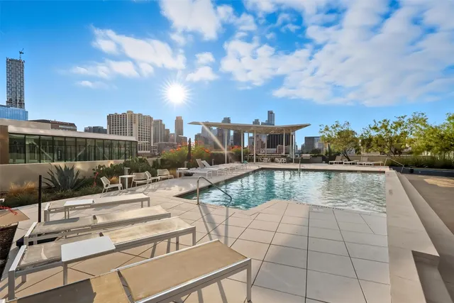 a view of swimming pool with outdoor seating and plants