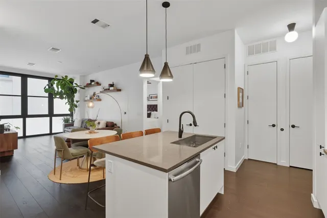 a view of a kitchen area with furniture and wooden floor