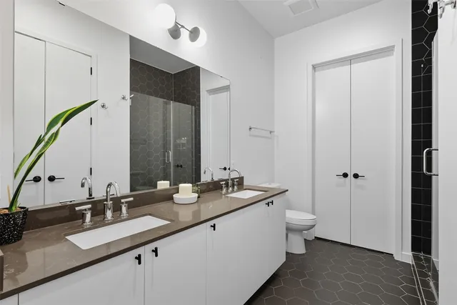 a bathroom with a double vanity sink and mirror