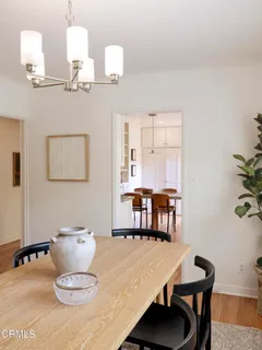a dining room with furniture and wooden floor