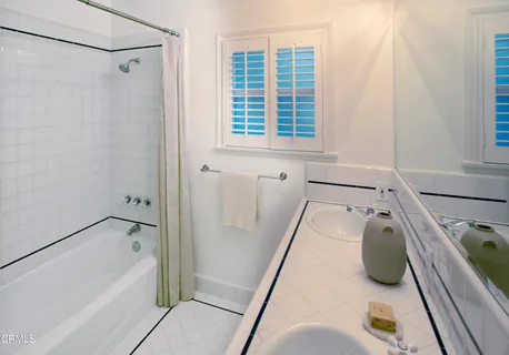 a bathroom with a tub and a window