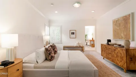 a bedroom with furniture and a dresser