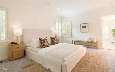 a bedroom with a large bed and a couch
